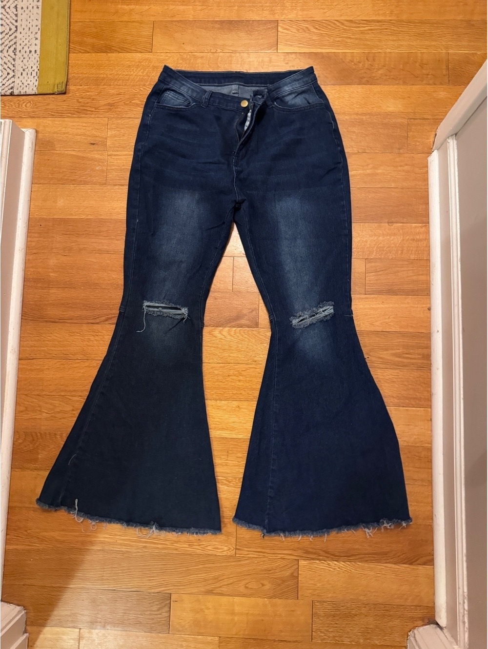 Dark wash distressed bell bottoms with raw edge